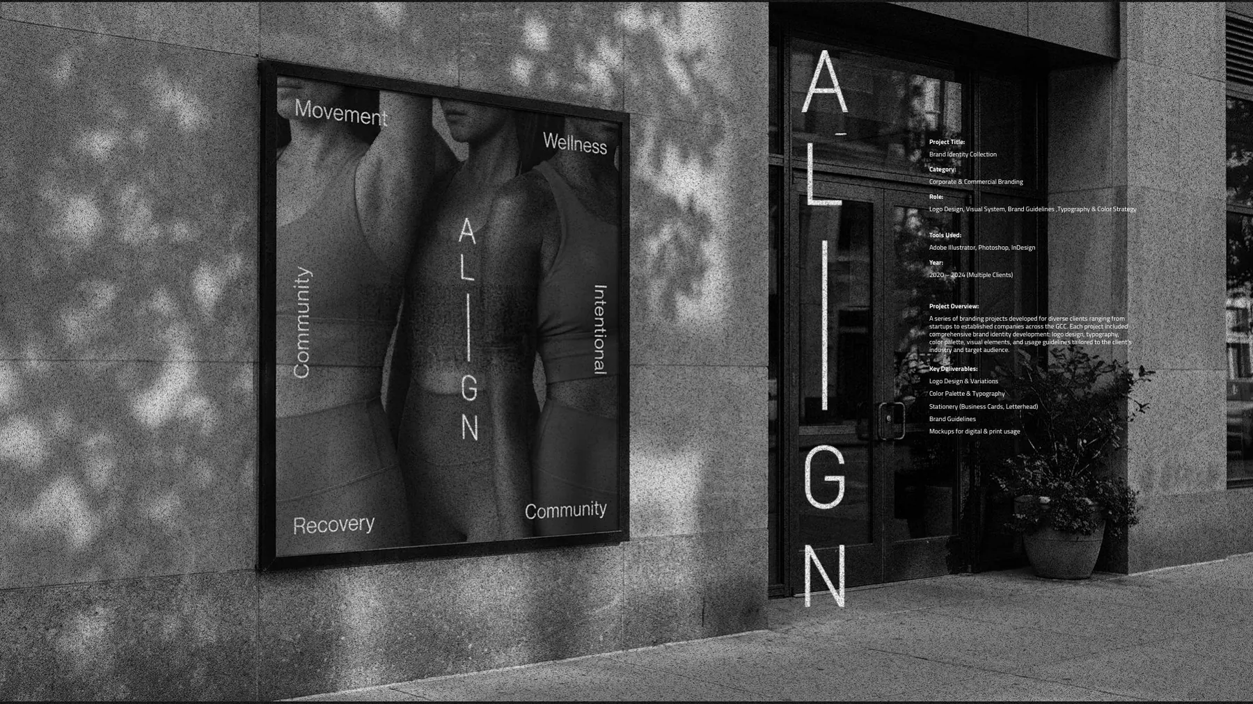 Align poster on a stone wall beside a vertical wordmark on glass